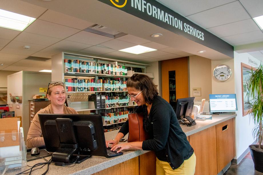 Public library reference assistant at her desk